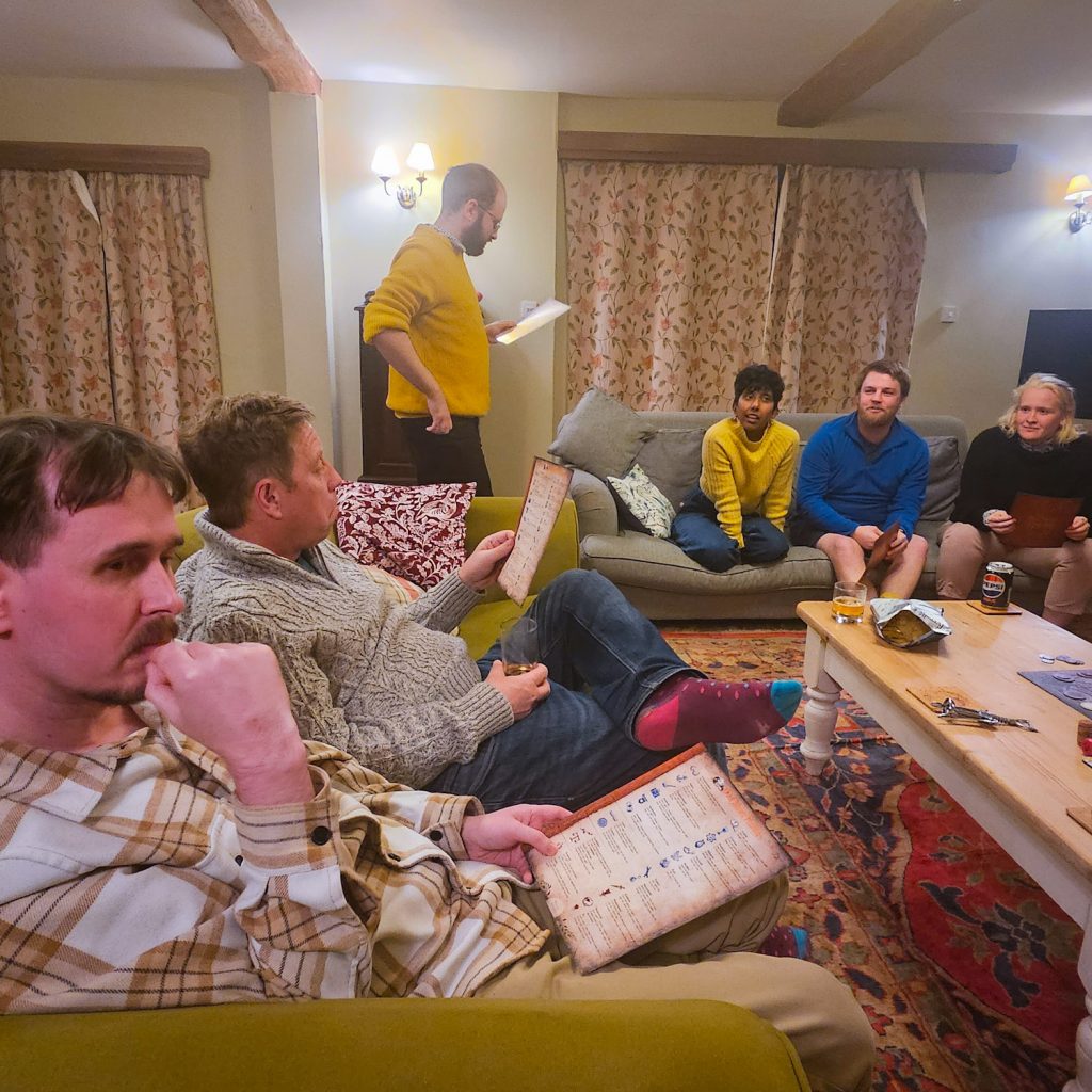 Players looking at scripts for Blood on the Clocktower social deduction game