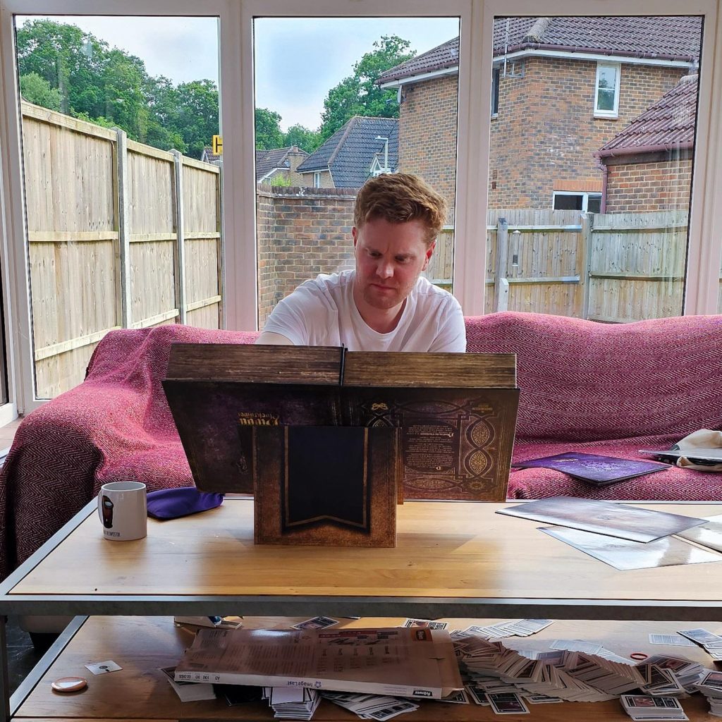 Storyteller consulting the Grimoire for Blood on the Clocktower social deduction game
