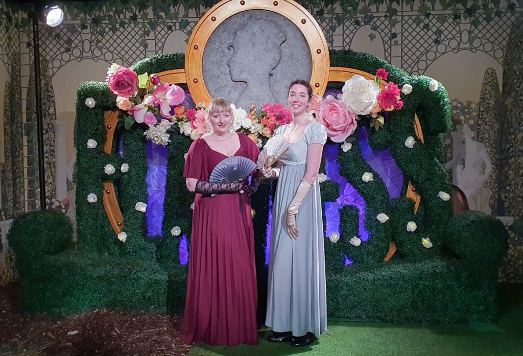 Becky and Matty posing in front of an elaborate floral display