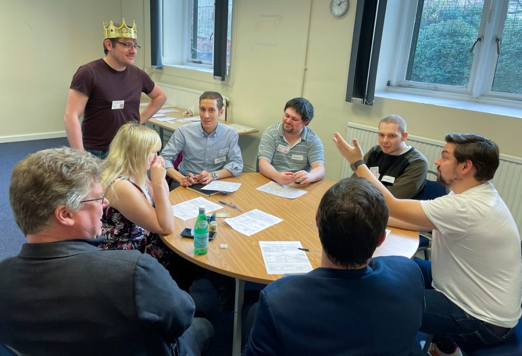 The King talks to a table of councillors