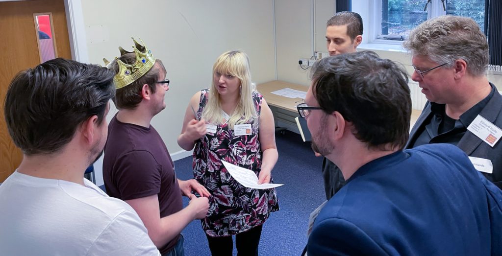 Becky talking to the King in frustration, while others look on