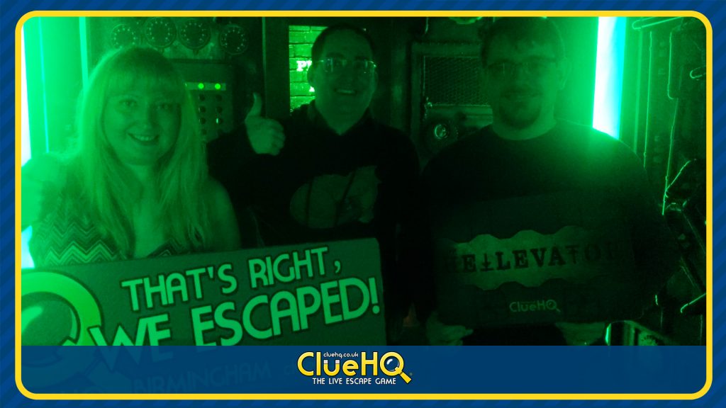 Becky, Ed and Tim holding a sign reading "That's Right, We Escaped" in their success photo