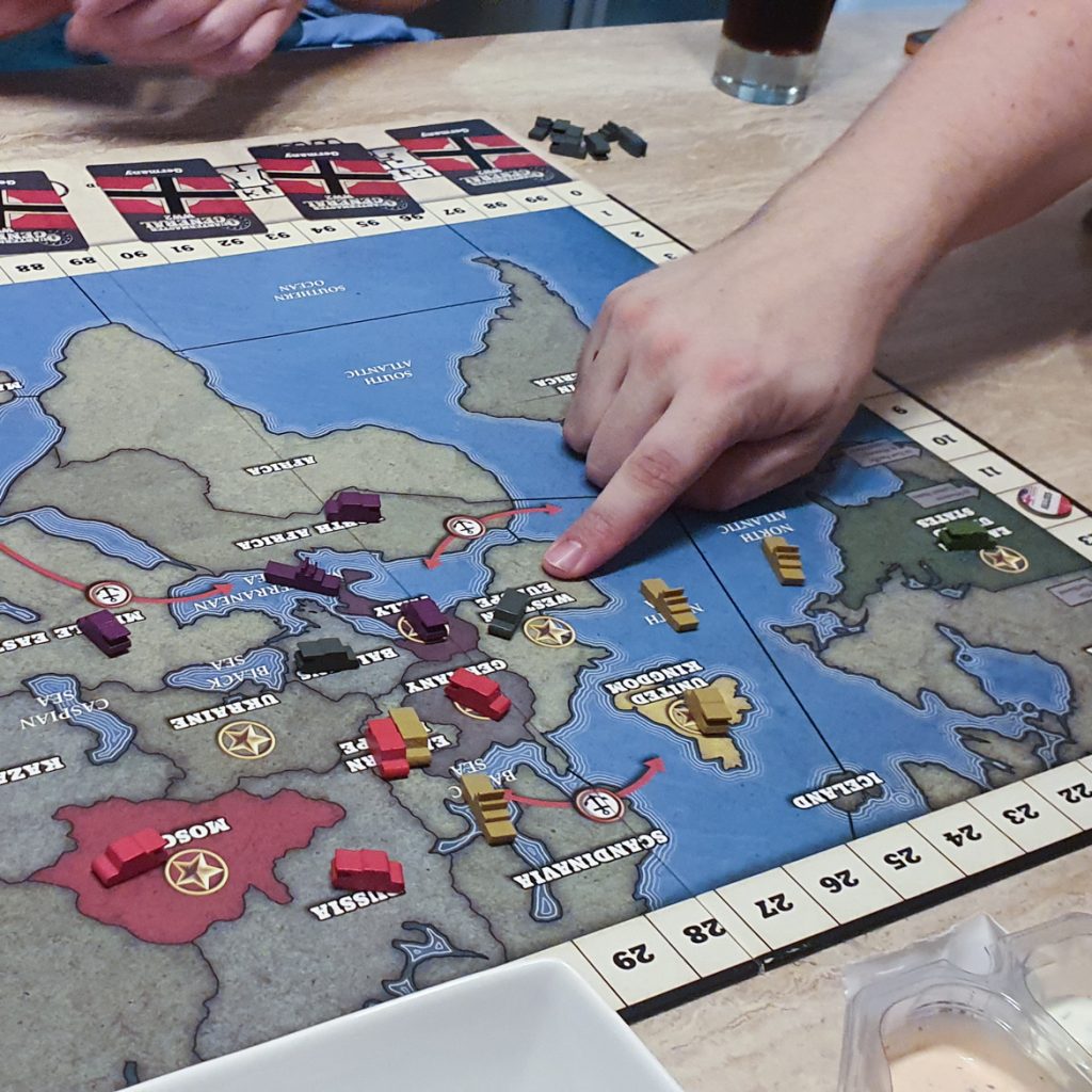 A player pointing at a piece on the Quartermaster General game board