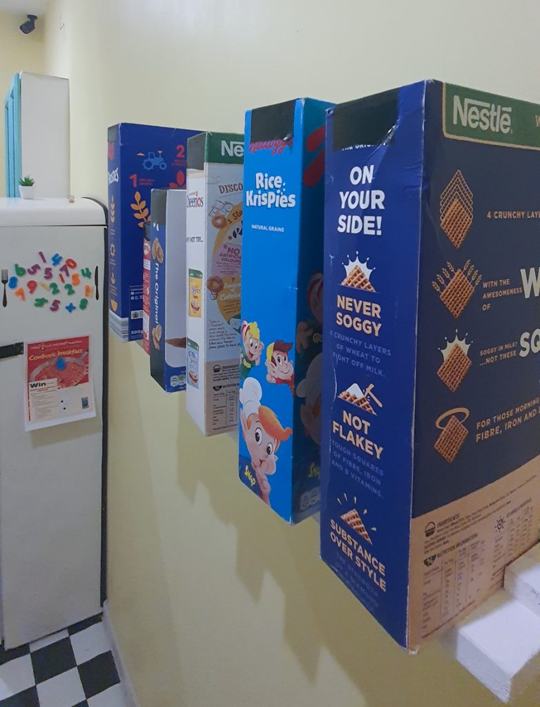 A row of cereal packets on a shelf