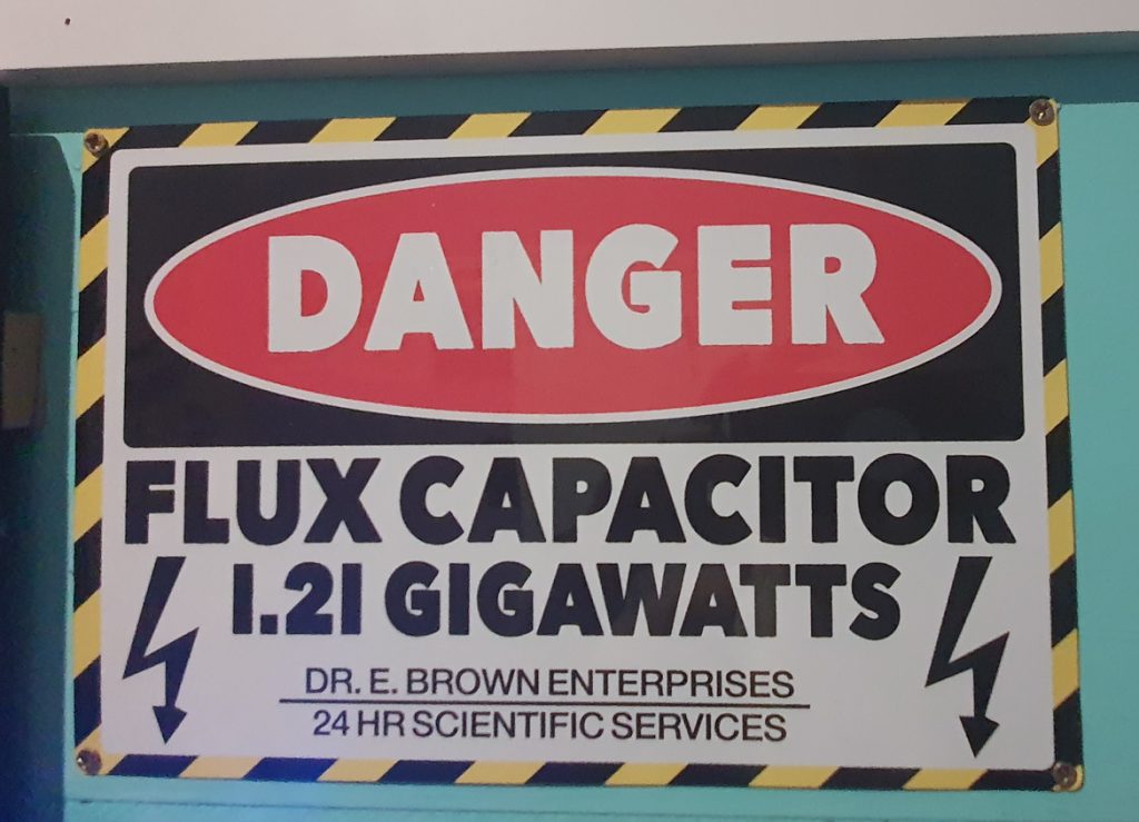 A sign reading: DANGER! FLUX CAPACITOR 1.21 GIGAWATTS