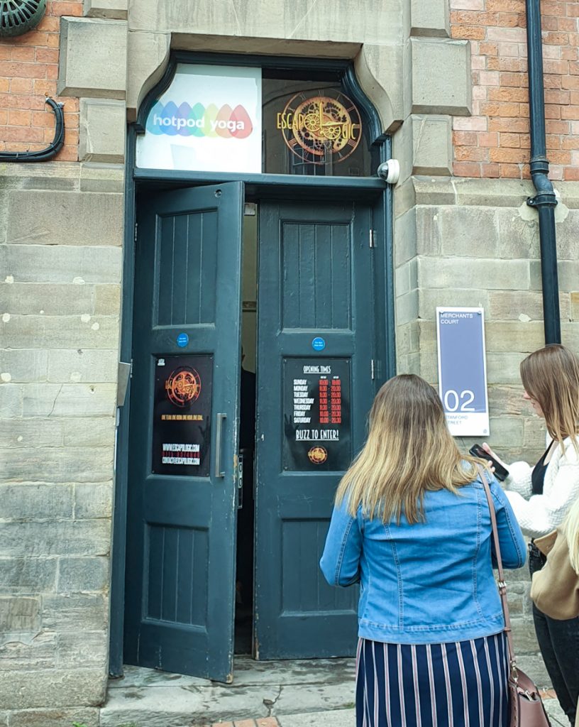 A tall door with an Escapologic sign above it