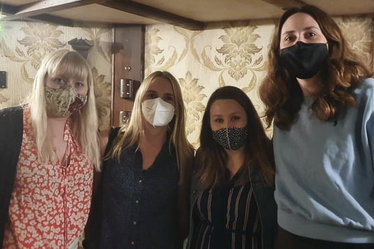 Becky, Ellie, Laura and Vicki smiling for their escape room success photo