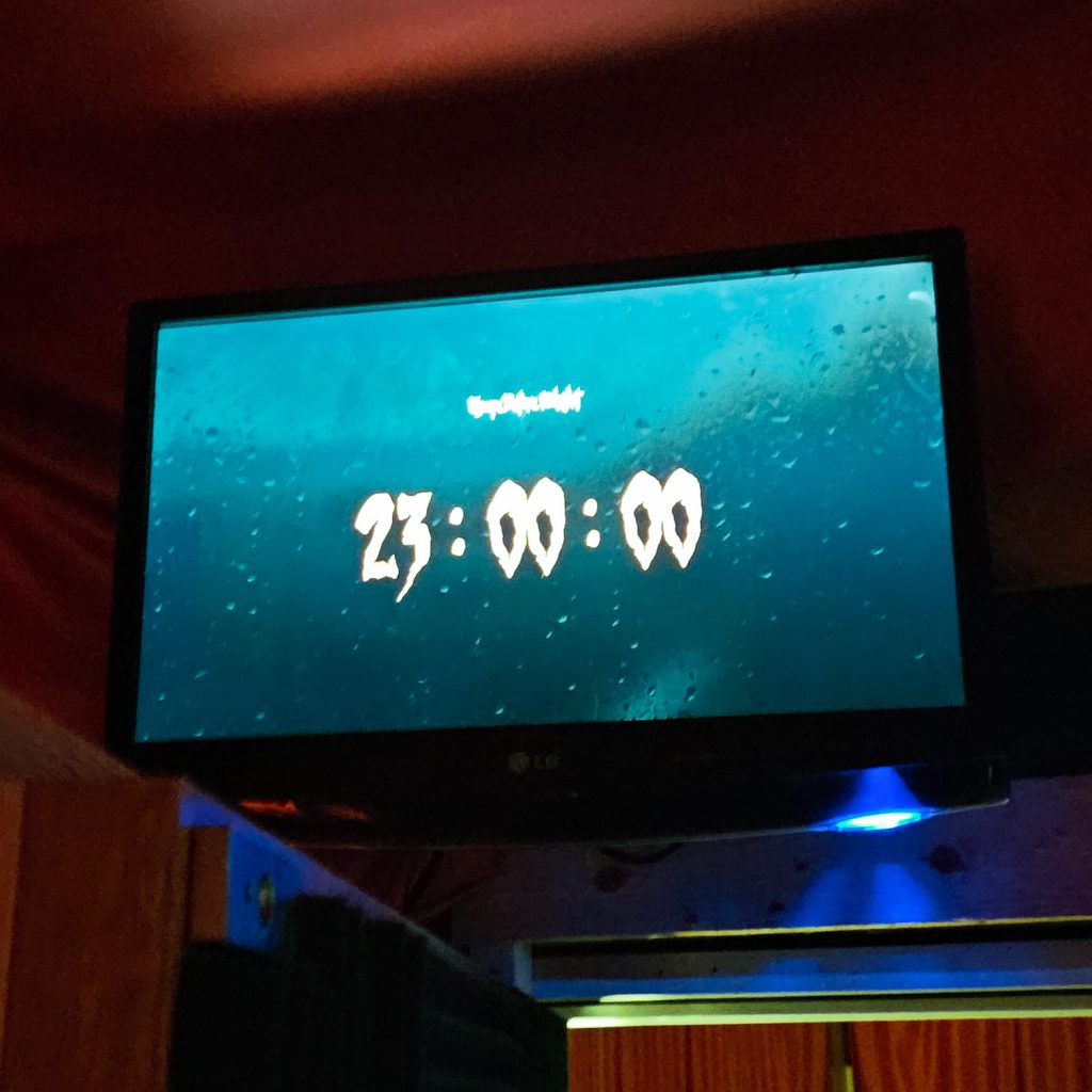A screen showing a digital clock reading 11pm