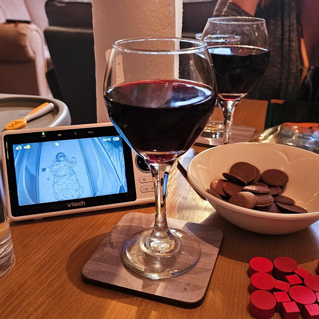 Wine, snacks, board game components and a baby monitor