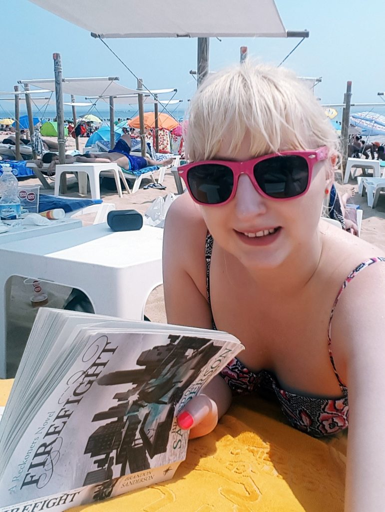 Lounging and reading a book at Carcavelos beach - Things to Do in Lisbon, Portgual, travel blog by BeckyBecky Blogs