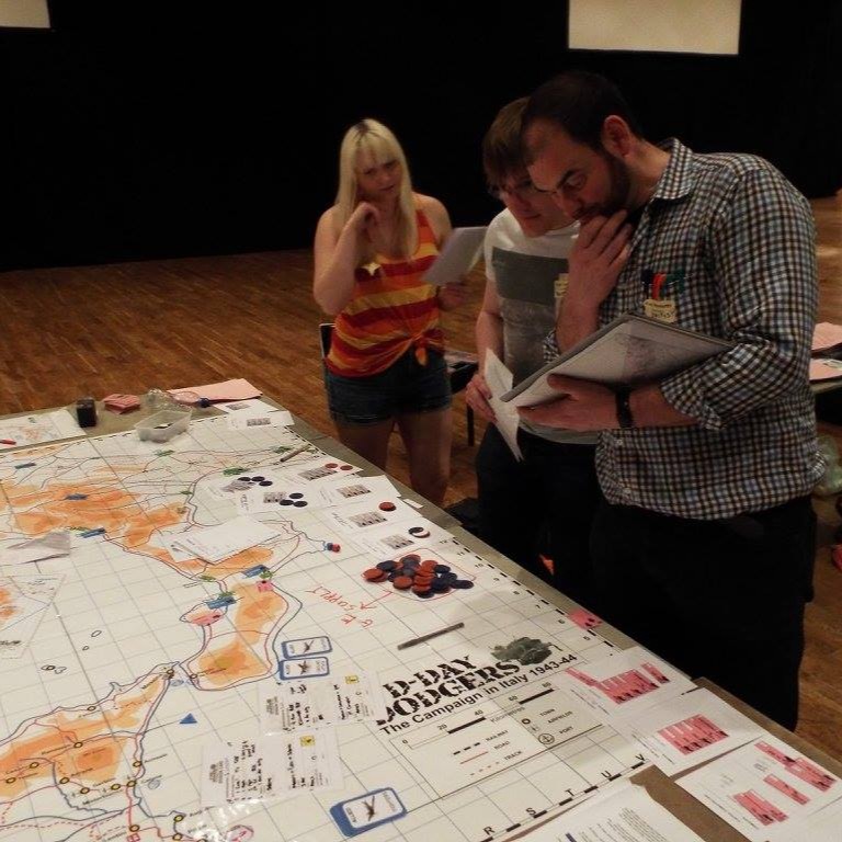 Facilitators looking at a megagame map