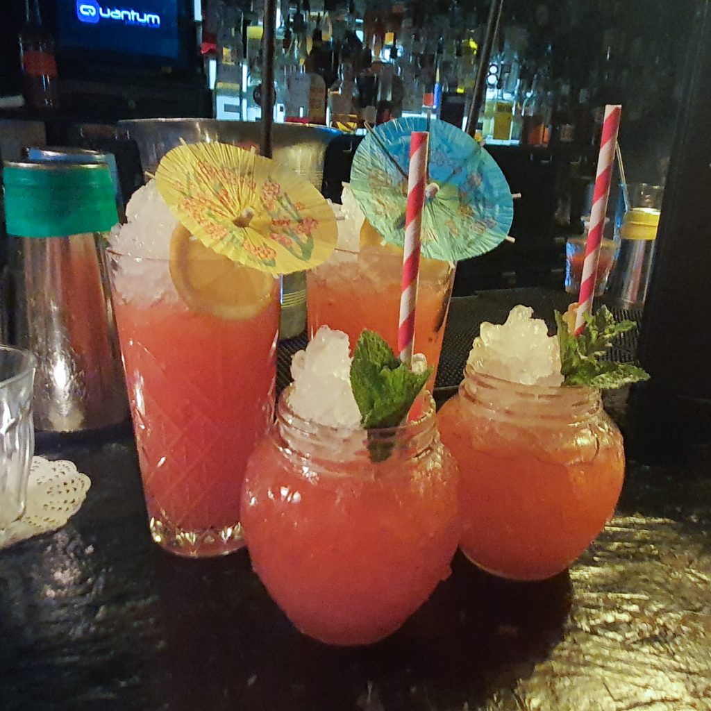 Four cocktails on a bar