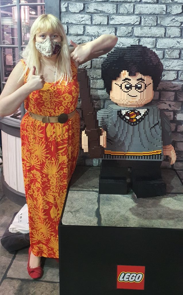 Becky giving a thumbs up next to a large Lego Harry Potter model