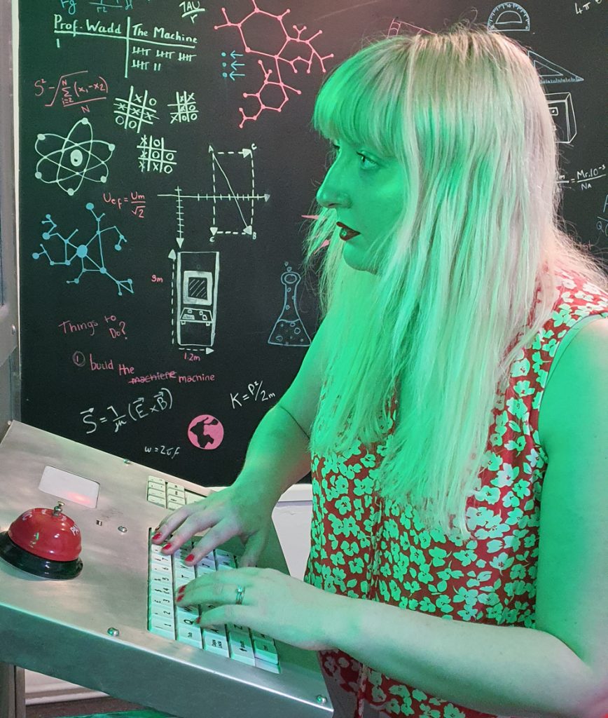 Becky typing on a keyboard, with a green light