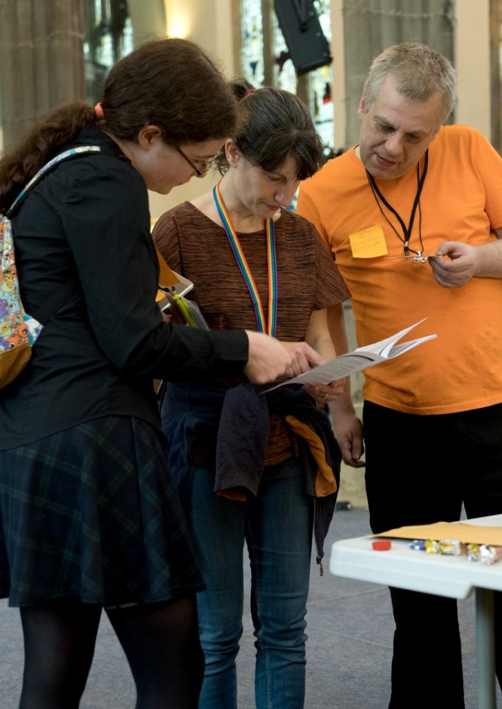 Pouring over a handbook - Trope High Megagame in Photos by BeckyBecky Blogs