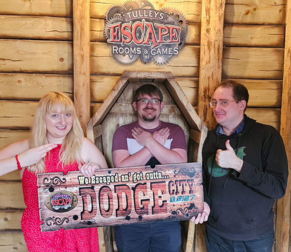 Becky, Tim and Ed posing for their success photo at the Dodge City escape room by Tulleys Farm