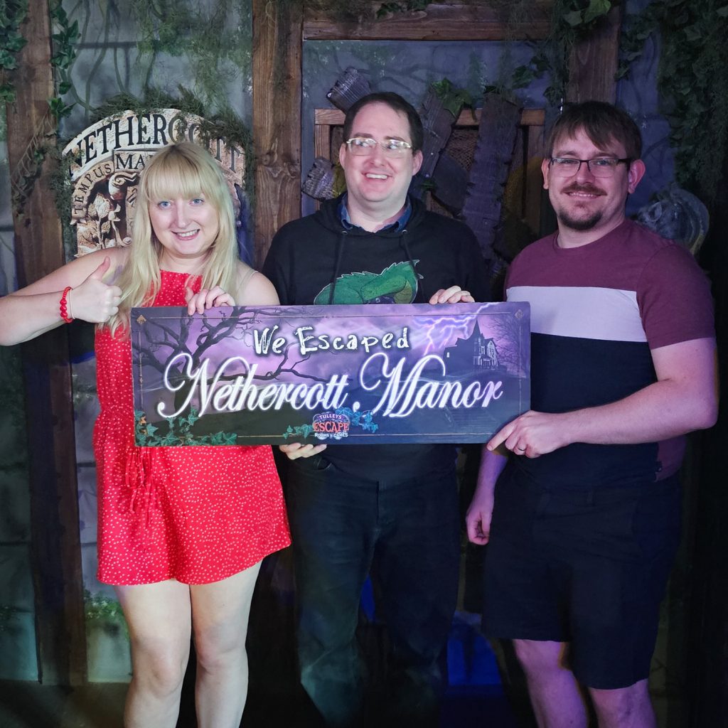 Becky, Tim and Ed posing for their success photo at the Nethercott Manor escape room by Tulleys Farm