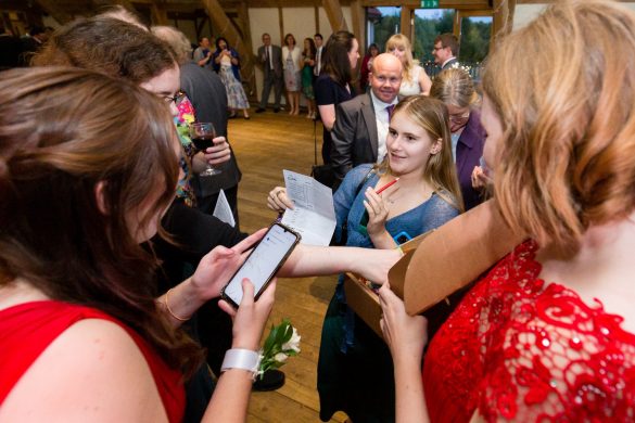 A wedding guest showing her results card to get her prize